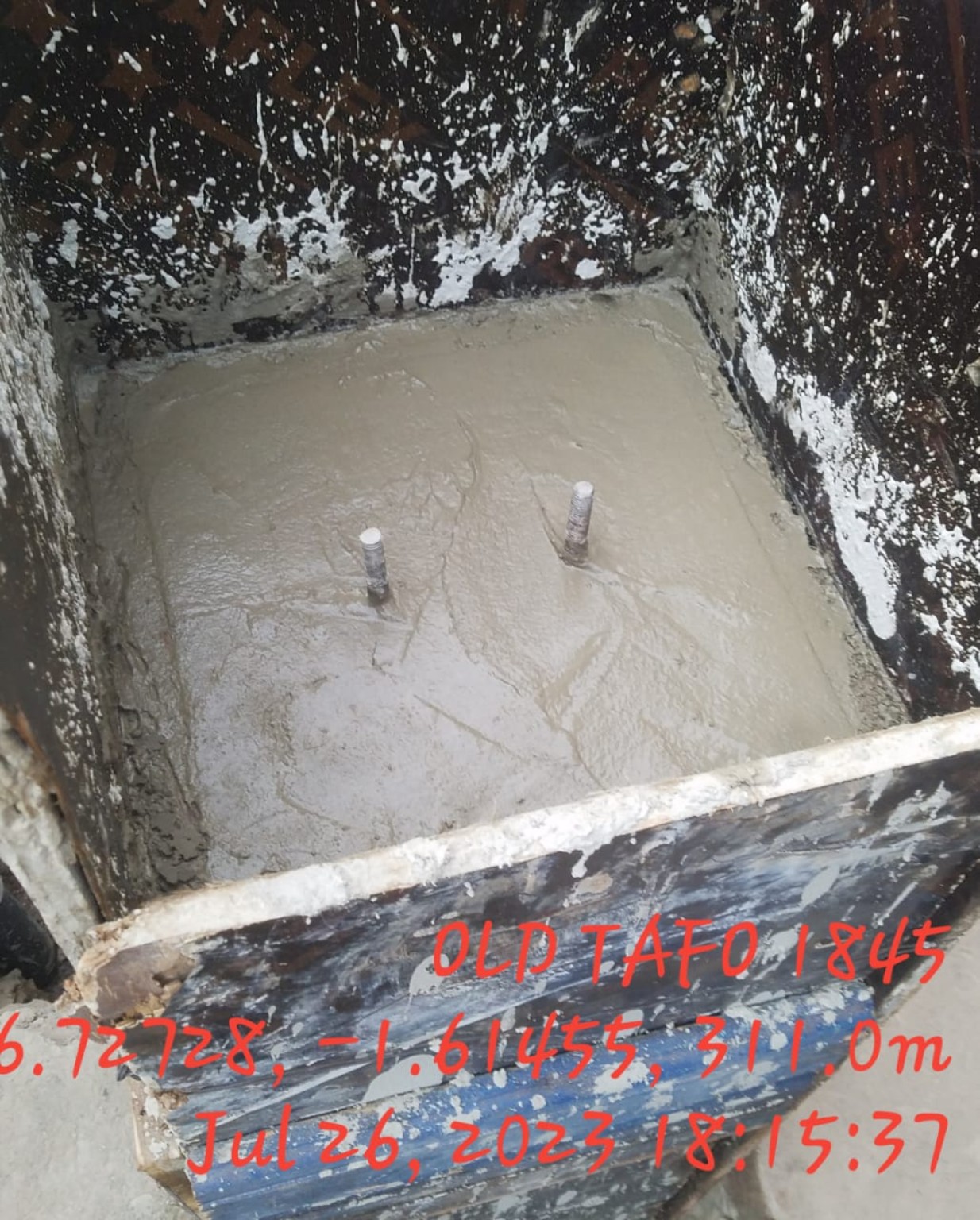 Completed concrete foundation base with anchor bolts