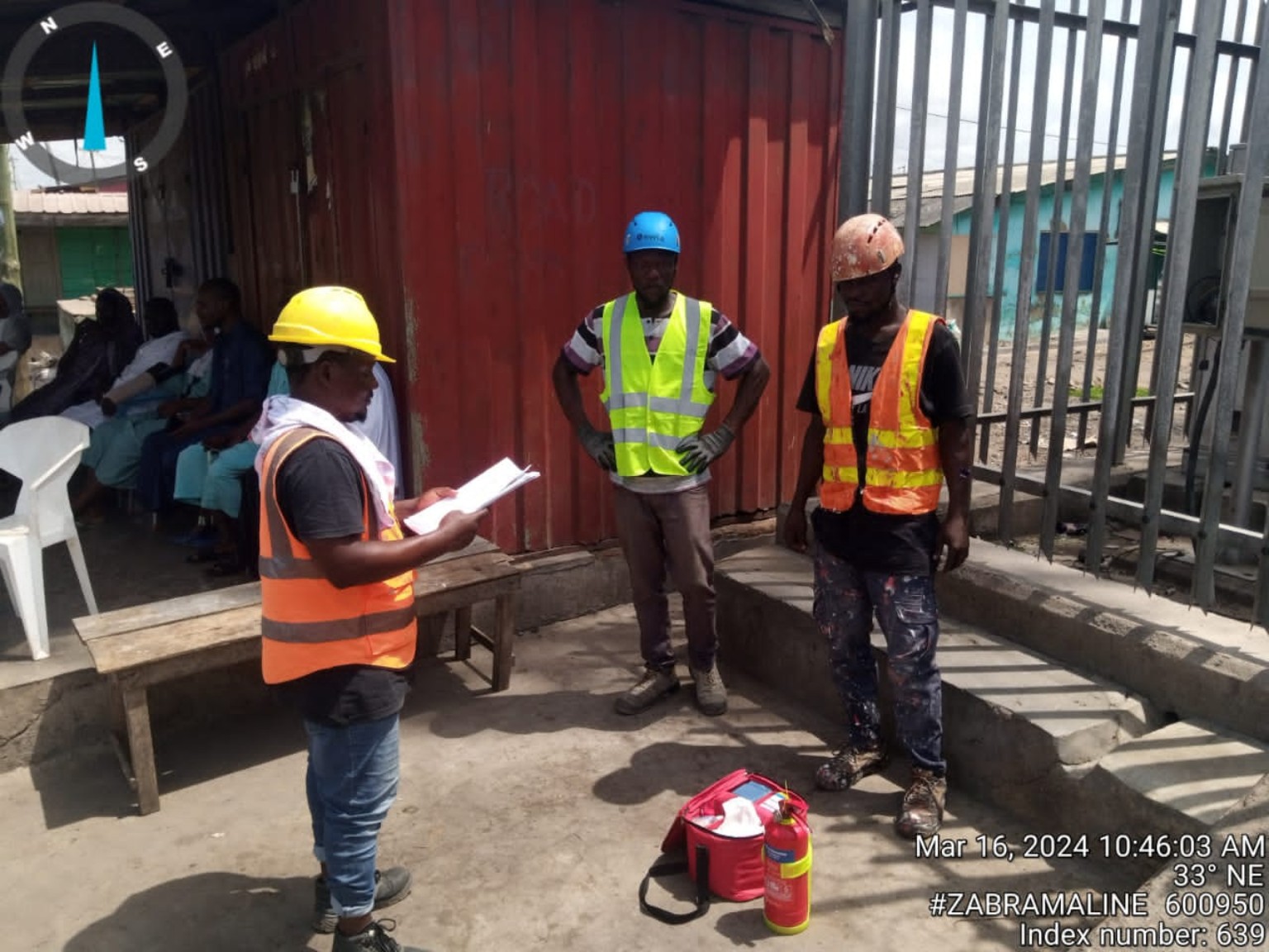 Workers receiving a safety and emergency response briefing