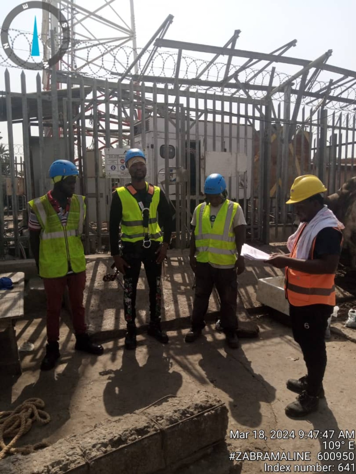 Project team conducting a safety briefing at a telecommunications site